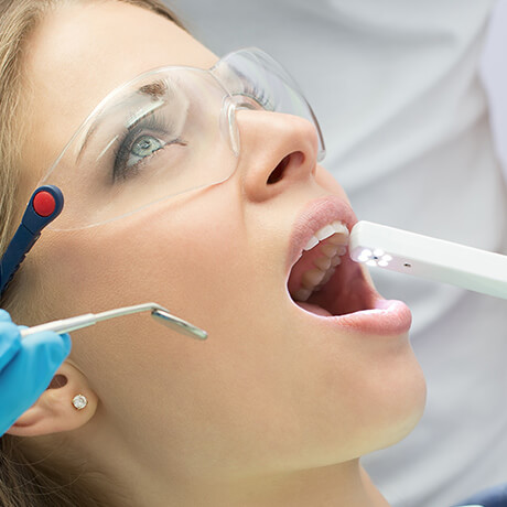 using an intaoral camera to examine inside a patient's mouth