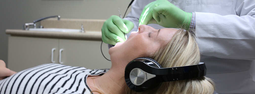 Dr. Renz examining a patient's teeth